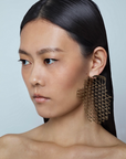 model wearing sculptural gold filicudi single earring with geometric design, handcrafted Italian fine jewellery