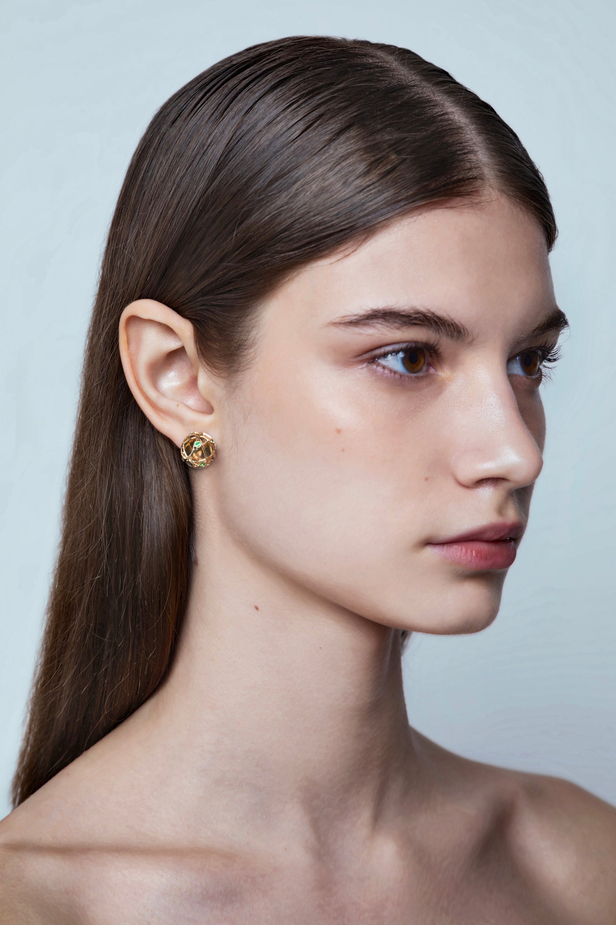 model wearing Jaipur Emeralds gold earrings in 18kt with sculptural spherical design, handcrafted Italian fine jewellery